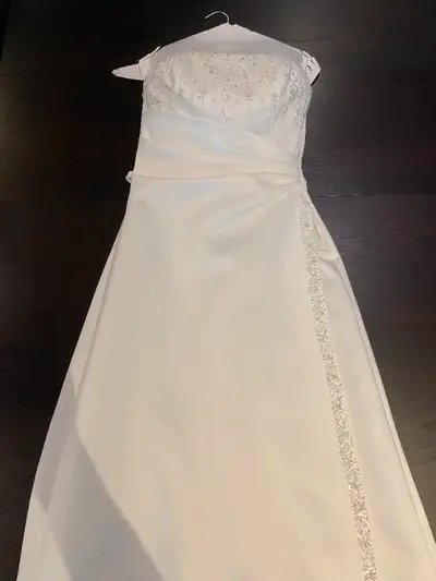 Selling a used white wedding gown dress. Used for wedding back in 2004. Dress was dry cleaned after...