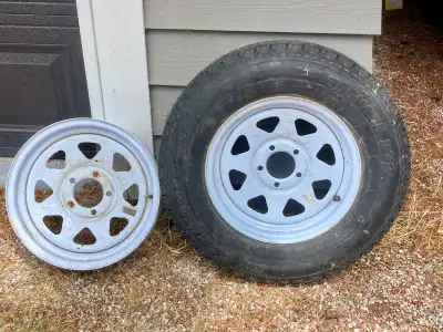 2 steel 15x5 trailer rims 1 brand new trailer tire - 205/75R15. 6 ply Load Rating C Sold together