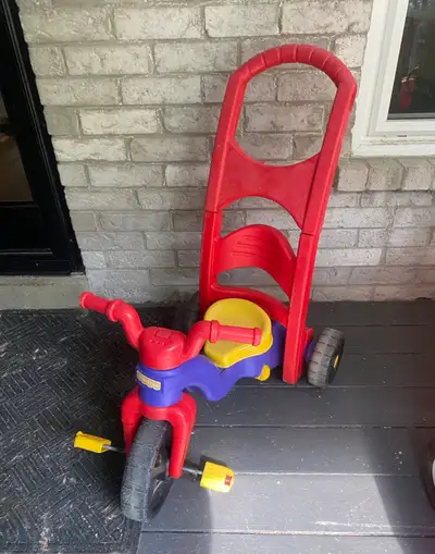 2 in 1 Fisher price tricycle. - Has bar that pops out for child to rest feet and be pushed - Working...