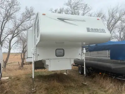 Fiberglass short box camper with slide. Electric jacks. Air conditioner 6 cu ft fridge 3487 lbs load...