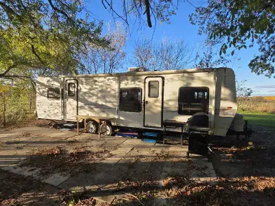 28 foot travel trailer, bedroom at back, large bathroom in the middle. Couch and dining table turn t...