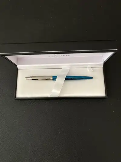 This is a Parker Jotter ballpoint pen in excellent condition, with a sleek blue barrel and chrome ac...