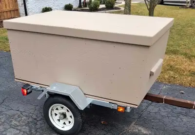 NEW. Utility trailer. Approx 48x48" bed. Weatherproof box lifts off for flatbed option. Galvanized f...