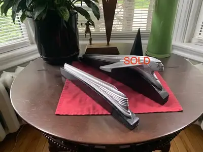 Two vintage car hood ornaments mounted on black wooden display blocks. - 1941 Chevrolet (train). $85...