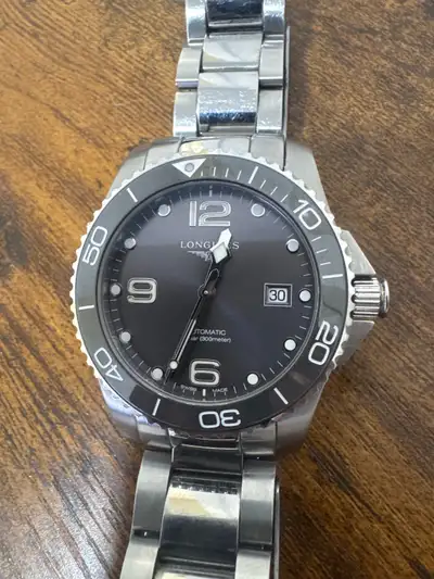 This is a used Longines men's watch, damage to the beige cardboard, a stylish timepiece with an auto...