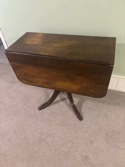 Beautiful antique hardwood drop-leaf table. Made of solid cherry with brass feet, finish is in excel...