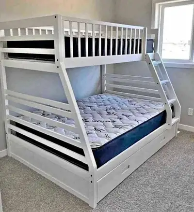 This is a sturdy white bunk bed, perfect for kids or a guest room, featuring a twin top bunk and a f...