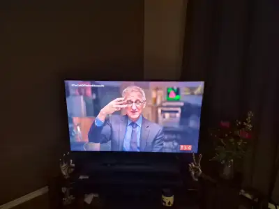 Samsung 50inch Smart TV, with surround sound and a TV stand., View more