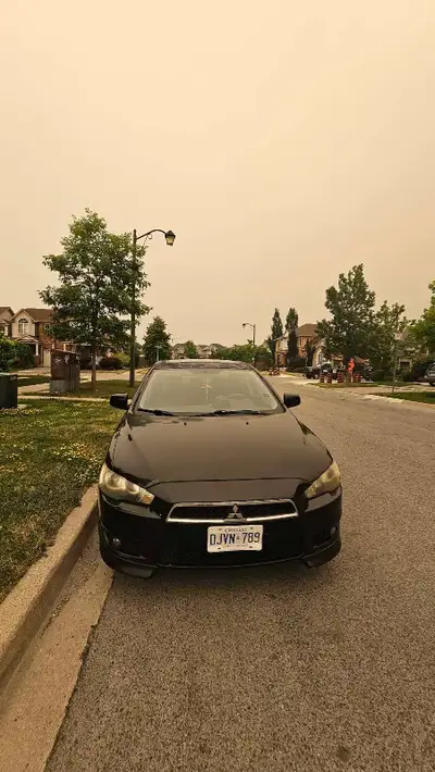 This reliable Mitsubishi Lancer is a pre-owned sedan that offers a dependable driving experience, pe...