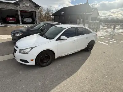 2014 Chevrolet Cruze. Engine light on - low boost. Comes with 2 sets of tires and rims.