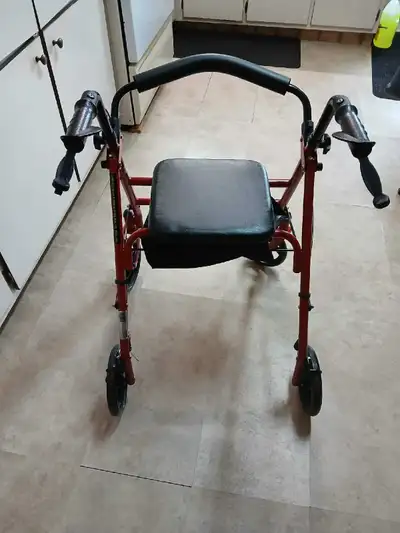 This pre-owned Drive Medical four-wheeled rollator is in good condition, providing reliable support...