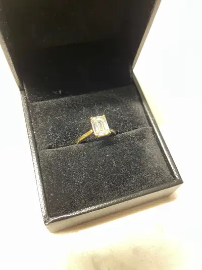 This is a beautiful and seldom-worn artisan created 1.53 ct Emerald cut diamond set into an 18k gold...
