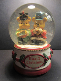 Vintage musical snow globe bears playing instruments.