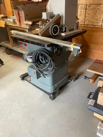 This Delta table saw is a robust piece of equipment ready for your workshop, featuring a sturdy buil...