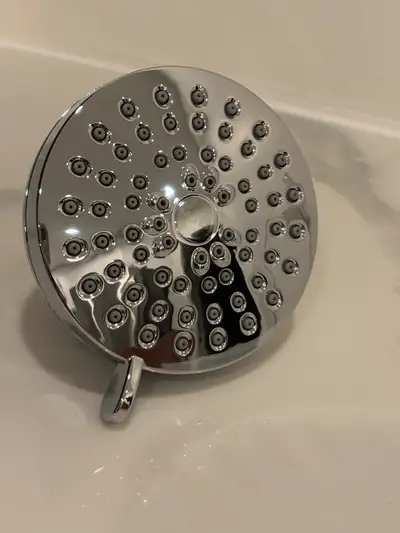 Brand new chrome finish showerhead from Moen. It has multiple spray settings for a customized shower...