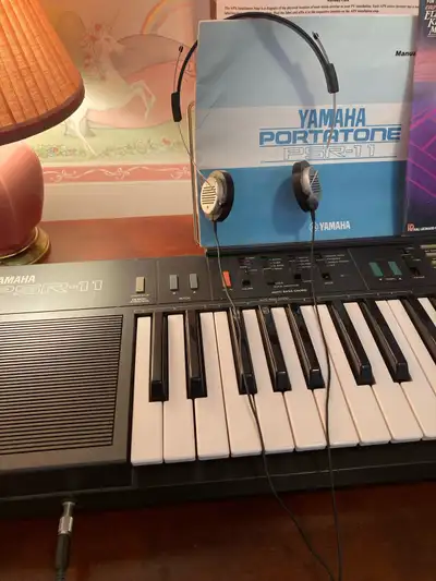 Yamaha electric organ with manual. 20 black keys/ 29 white with head set. Original owner. Like new....