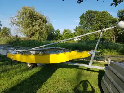 Yellow catamaran 14 feet. Comes with galvanised Shorelander original trailer. One original sail, sto...