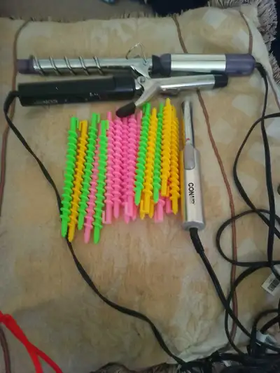 Conair curling iron 3 different size . Includes a set of colorful spiral hair curlers. Great for cre...