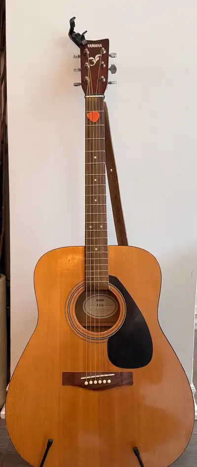 Yamaha Acoustic Guitar. Leather strap, capo and stand included., View more