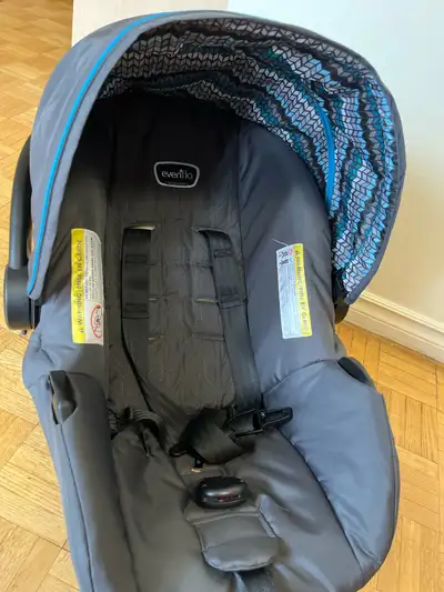This is an Evenflo car seat and holder, perfect for safely transporting your little one! The car sea...