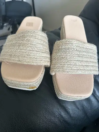 Selling new women’s beige wedge sandals. The sandals are a wide fit and the size is USA 7 (EUR 38)....