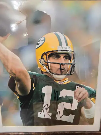 This is an Aaron Rodgers signed and framed photo, a must-have for any Green Bay Packers fan. This pi...