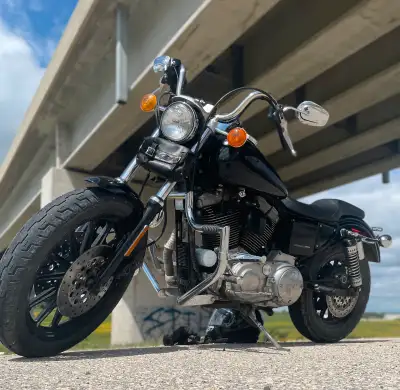 This is a used Harley-Davidson motorcycle with a sleek black finish, perfect for cruising and turnin...