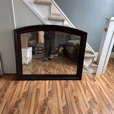 Dark brown large mirror in perfect condition was used on my dresser. Mirror doesn't fit in my space...