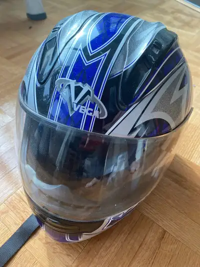 This Vega helmet is a sturdy piece of protective gear for motorcycle or scooter riders, displaying a...