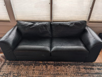 Free large two seater leather sofa - has puppy damage