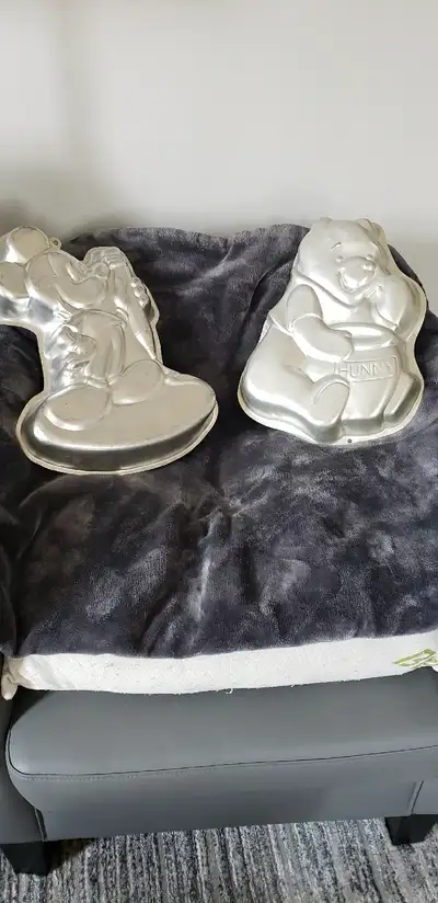 Character cake pans. 4 in total. No instructions. Various prices. Mickey Mouse is $35. Winnie-the-Po...