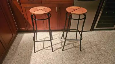 Two bar stools. Wood seat with metal frame. 30 inches tall.