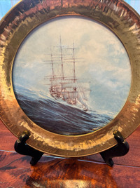 Hand painted ceramic tile with an image of a sailing ship.