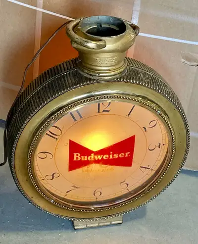 For sale is a vintage “Budweiser: King of Beers” pocket watch hanging clock (circa 1959). This origi...