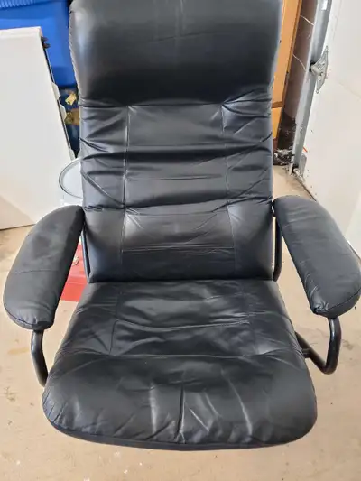 Black leatherette swivel/recliner with matching foot stool., View more