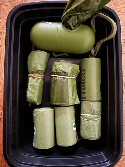 Lightly used dog poop bag holder and 6 bags.