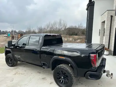 This hard folding topper is designed for a GM 2500HD pickup truck, providing excellent protection an...