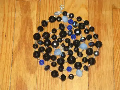 I have a long glass beaded necklace by White House Black Market. It is mainly faceted black jet glas...