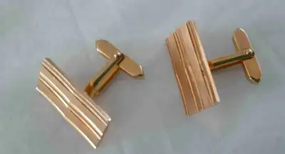 Add a touch of vintage class to your wardrobe with these stylish gold-tone cufflinks, perfect for an...