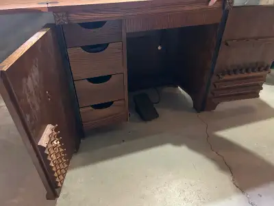 Solid wood cabinet with lots of storage for thread and supplies. Space saving design to cleverly hid...