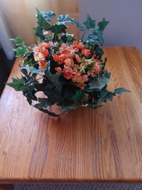 Artificial flowers in a embossed metal planter 