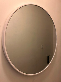 Circular wall mirror with white frame