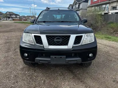 This is a well maintained, used, black 2015 Nissan Frontier Pro 4X V6 Crew Cab, with a sunroof and t...