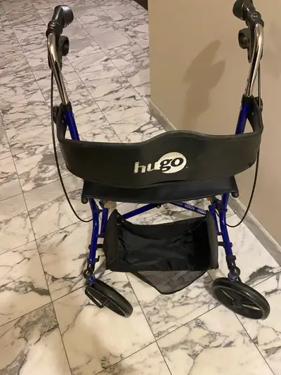 This Hugo walker is equipped with four wheels, brakes, and a seat, providing excellent mobility and...
