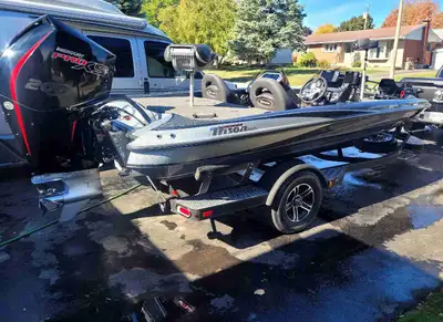 Immaculate bassboat 18 ft 8 in. 94 in beam. Dual console. 200 hp Pro XS 136 hours.EZ Loader trailer...