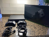 Xbox One X 1TB + 2 controllers + play and charge