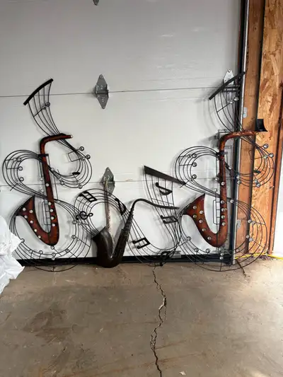 Set of three matching metal musical wall art pieces featuring saxophones and flowing music notes. Ru...