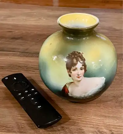 This is a used Royal Vienna Germany vase featuring a portrait of a woman. The vase has gold detailin...