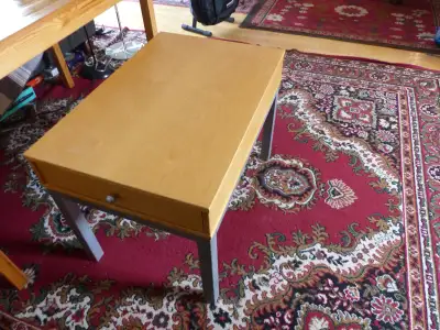 Table or bench with sliding drawer.