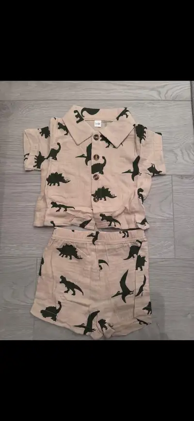 This adorable dinosaur print outfit is brand new and ready for your little one, featuring a short-sl...